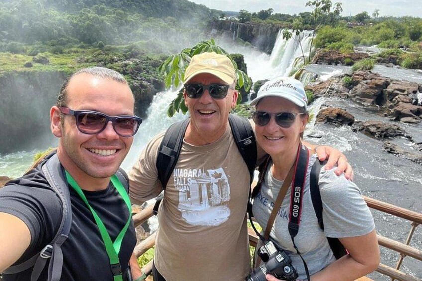 Three people taking a selfie with a waterfall in the background. 4