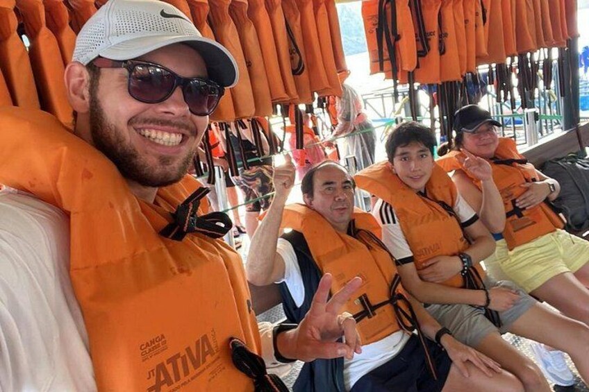 People wearing orange life jackets in a store. 2
