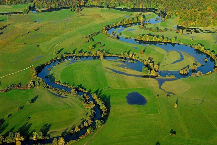 A golf course with winding water channels and green fields. 1