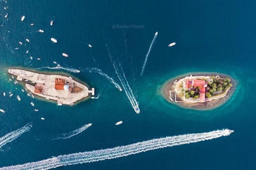 An aerial view of two islands with boats and wake trails in the water. 4