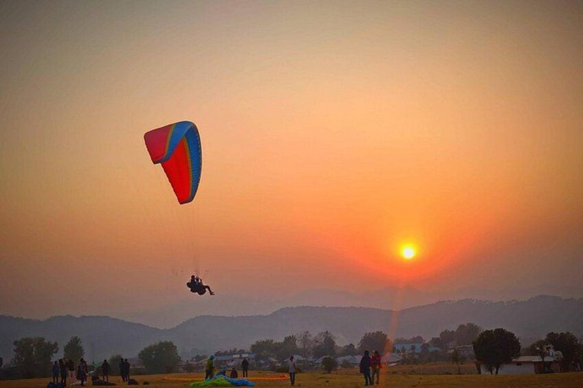 A sunset with a kite flying in the sky. 1