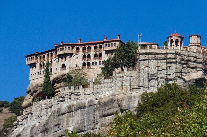 A historic building perched on a rocky cliff. 5