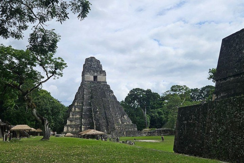 A large pyramid-like structure surrounded by trees and grassy areas. 3