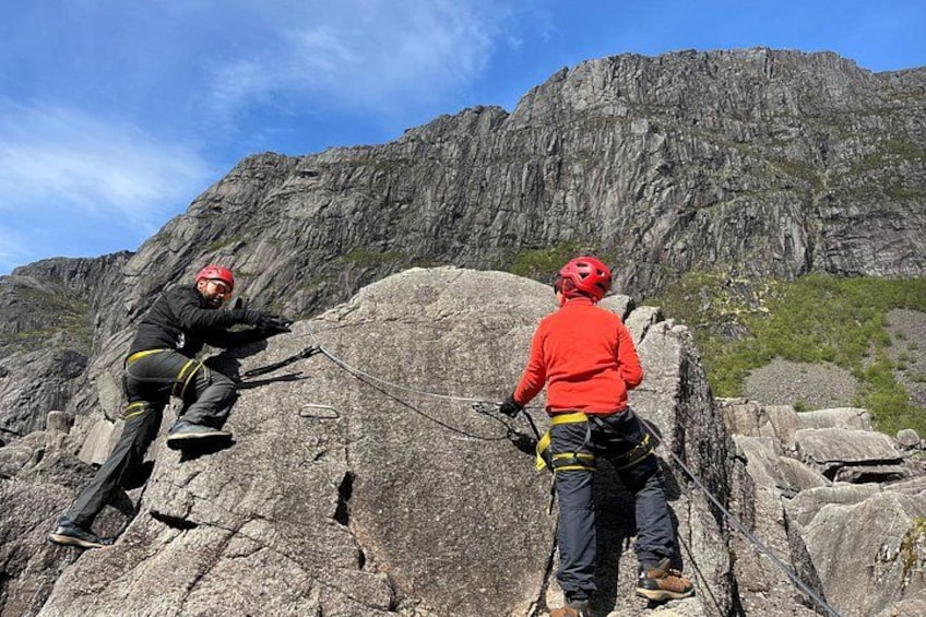 Two climbers on a rocky mountain with a clear sky. 4