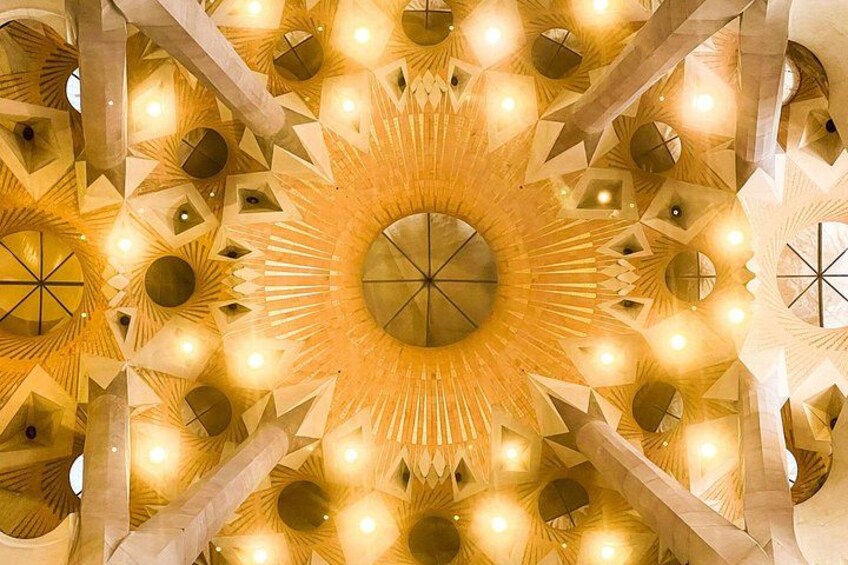 A detailed ceiling with geometric patterns and circular lights. 2