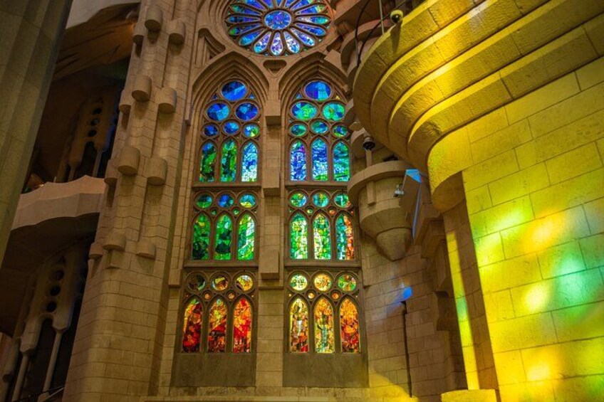 A building with large stained glass windows and a circular stained glass window at the top. 3
