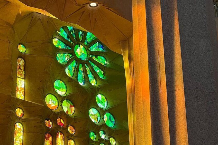 A stained glass window with a circular design and multiple smaller circular patterns. 2
