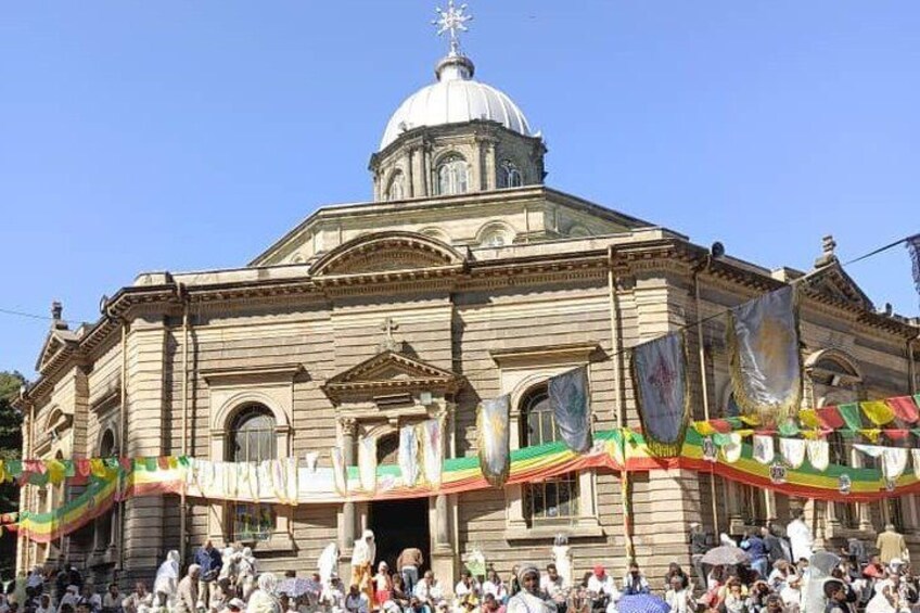 A large building with a dome and columns, surrounded by a crowd. 5