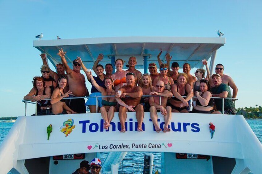 Un groupe de personnes se trouve sur un bateau, et on peut voir les inscriptions « Tulum Tours » et « Los Corales, Punta Cana ». 4