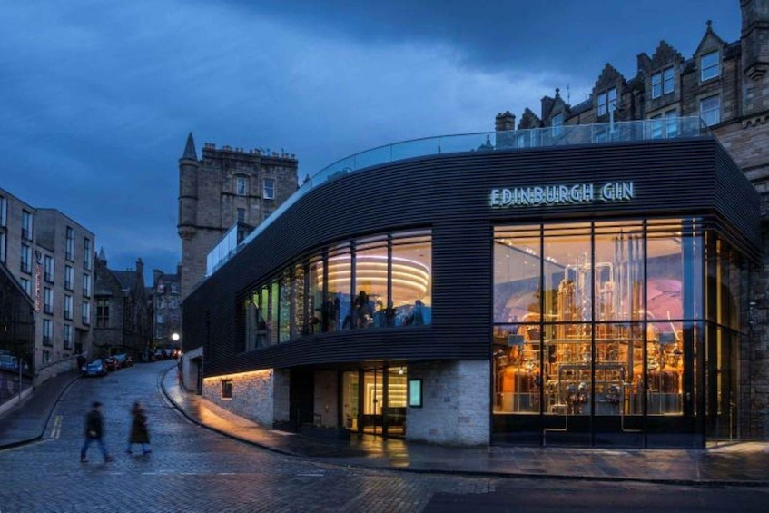 A modern building with a glass facade and the sign "EDINBURGH GIN". 1
