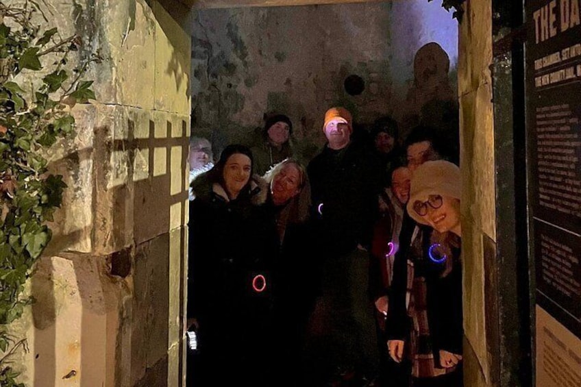 Un grupo de personas de pie en un umbral, con un letrero que dice 'THE DAY'. 2