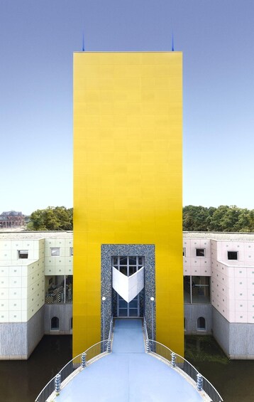 A modern building with a yellow facade and a central entrance. 4
