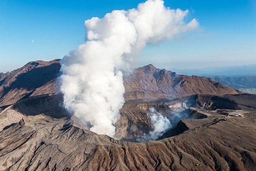 A volcanic landscape with a large plume of smoke rising from a crater. 3