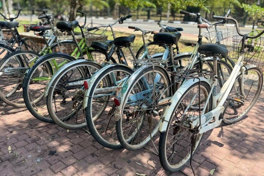 A row of bicycles parked on a brick pavement. 4