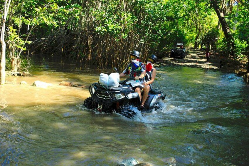 A river with a motorized watercraft carrying two people. 3