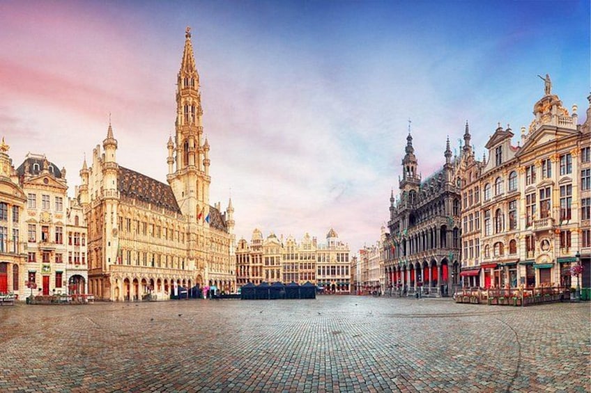 A historic square with ornate buildings, a prominent tower, and cobblestone pavement. 3