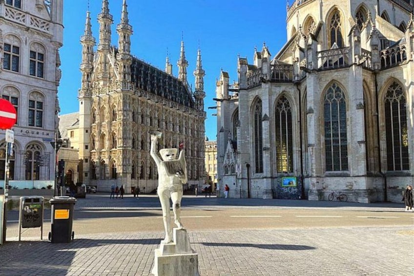 A statue in a square with historic buildings in the background. 2