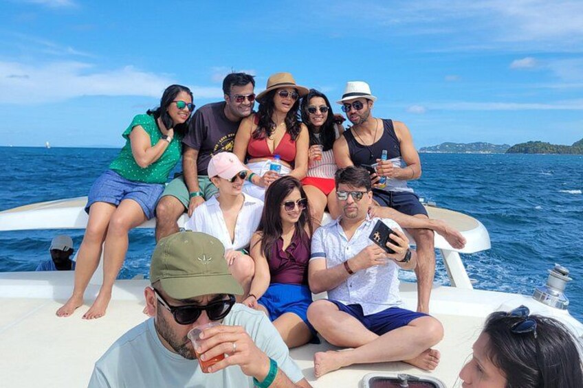 A group of people on a boat with the sea and a distant shoreline in the background. 5
