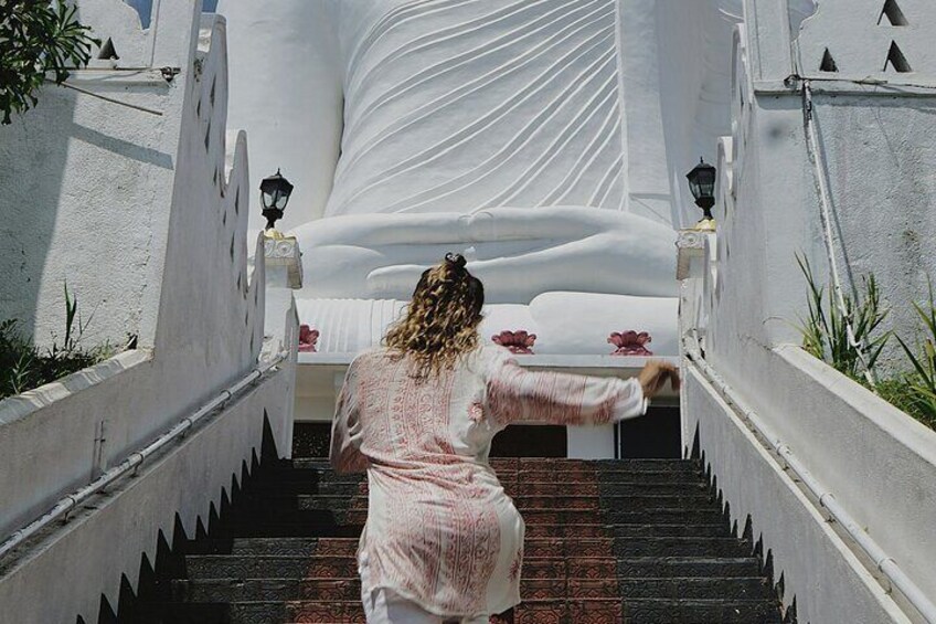 A person descending a staircase with a white wall and patterned steps. 3