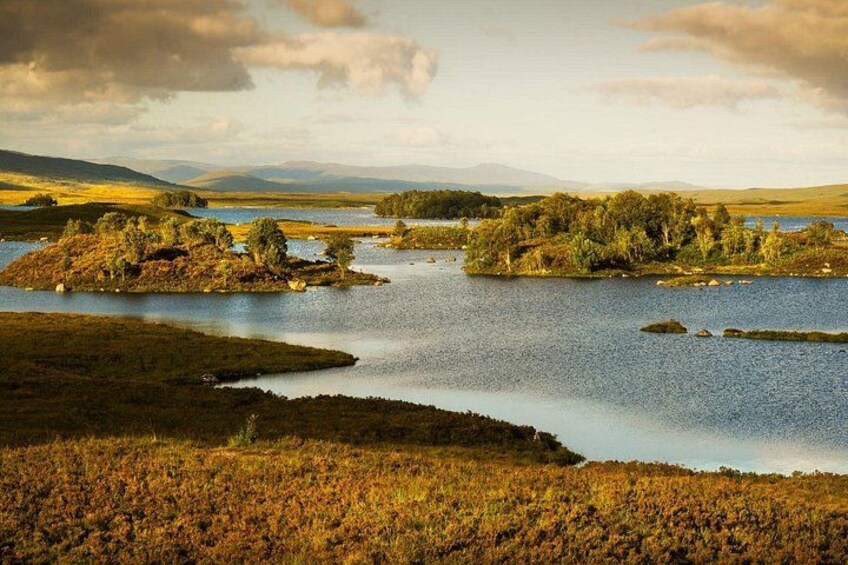 A landscape with a lake, islands, and distant mountains. 2