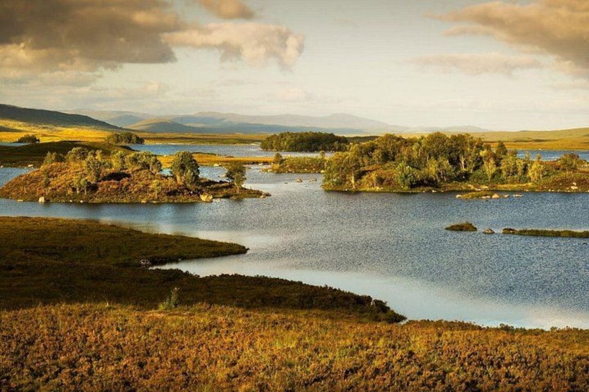 A landscape with a lake, islands, and distant mountains. 4