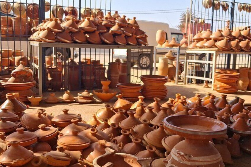 A variety of terracotta pots and containers displayed outdoors, likely for sale. 3