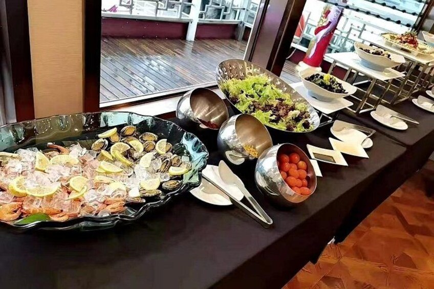 A buffet table with seafood, salads, and various dishes. 2