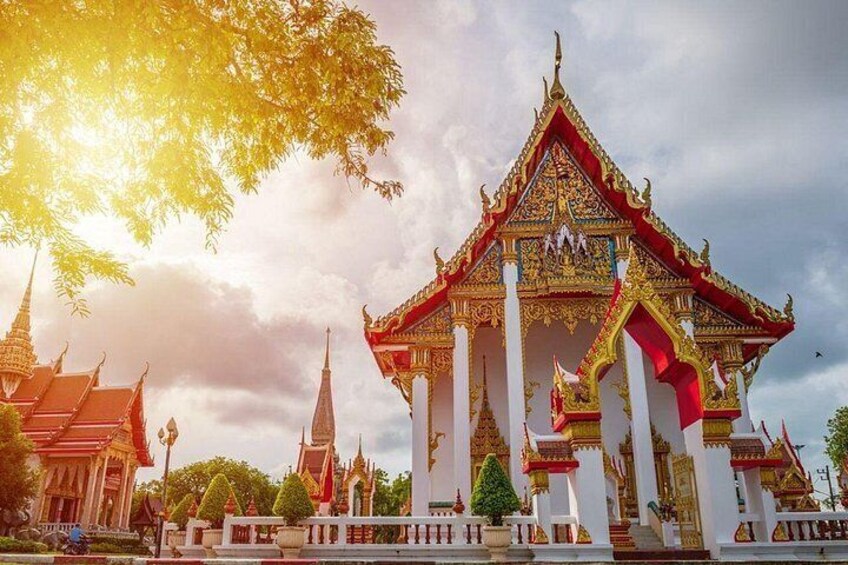 A traditional Thai temple with ornate architecture, a prominent central structure, and a surrounding complex. 3