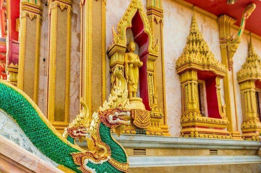 A golden dragon sculpture in front of a temple with intricate architecture. 2