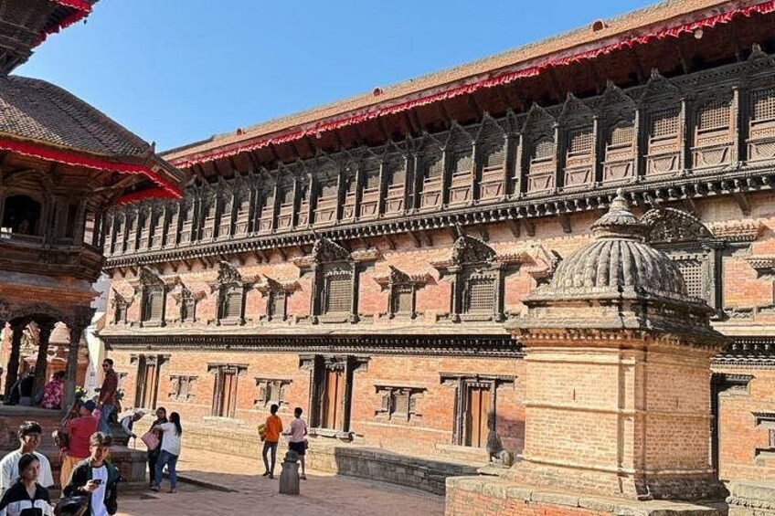 A historical building with intricate brickwork and domed structures. 5