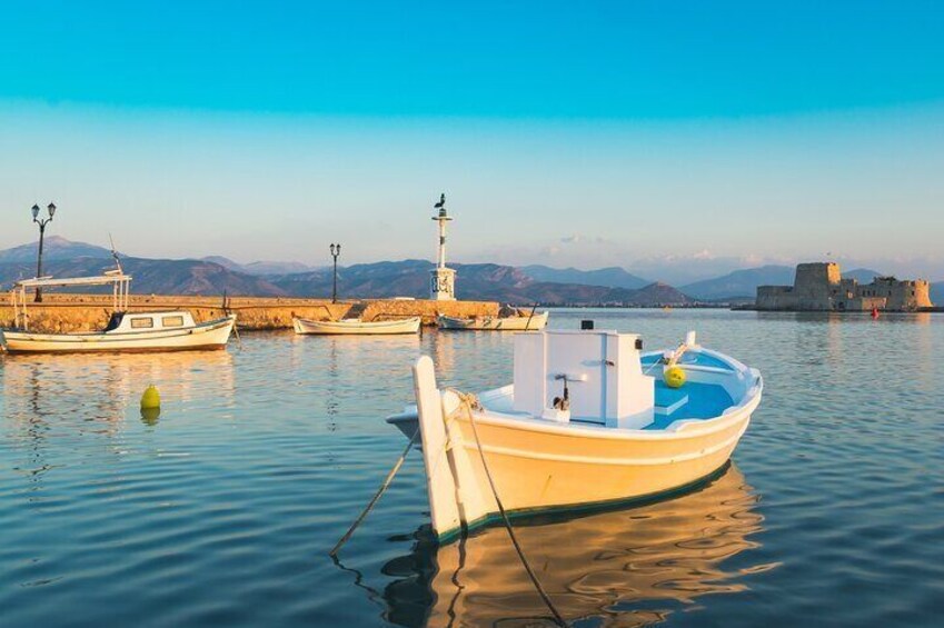 Serene evening views of Nafplio’s port, with fishing boats and the iconic Bourtzi Fortress. 5