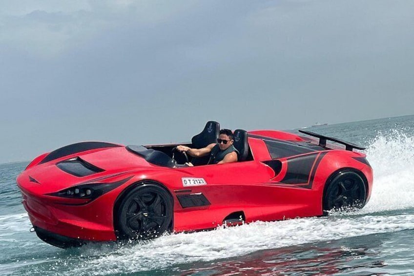 A red sports car driving on water. 1