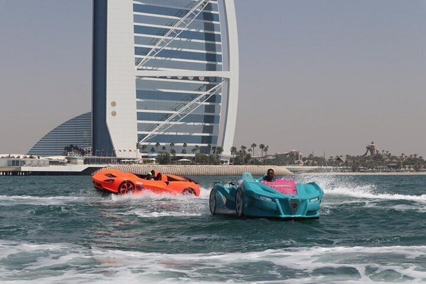 Two watercraft on a body of water with a modern building in the background. 2
