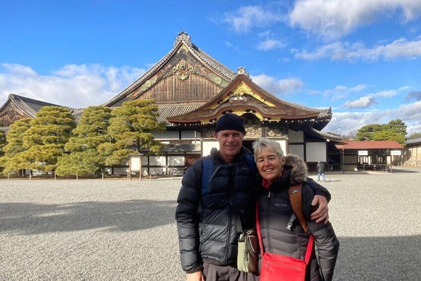 A traditional Japanese building with a tiled roof and wooden structure. 2