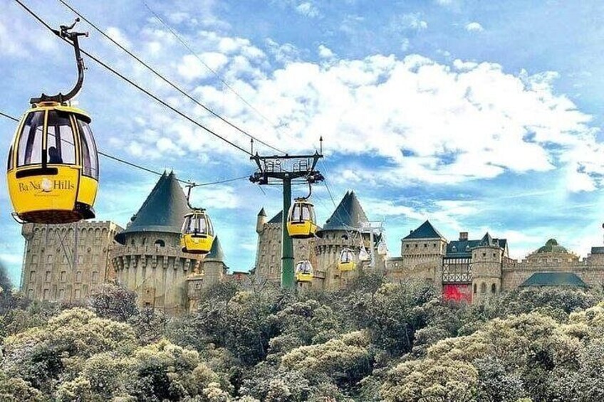 A castle with multiple towers, a cable car system, and dense shrubbery. 2