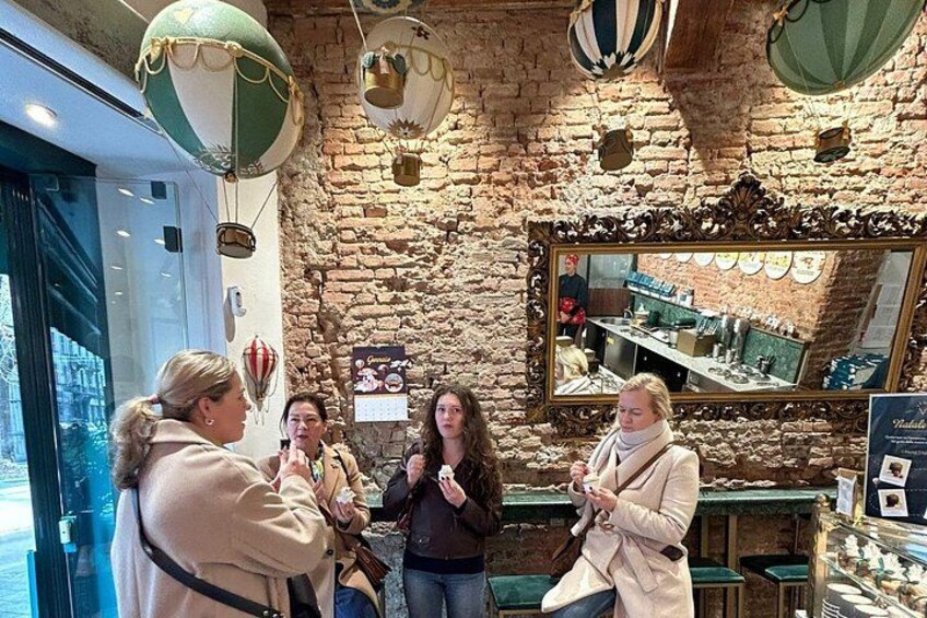 A brick-walled interior with a mirror, balloons, and a person holding a camera. 3