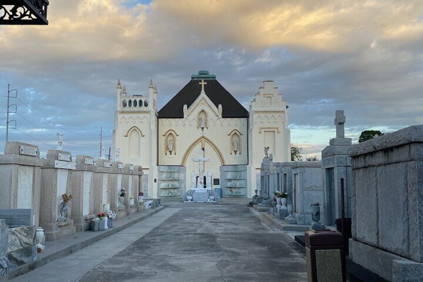 A church with a cross on top, surrounded by gravestones. 2