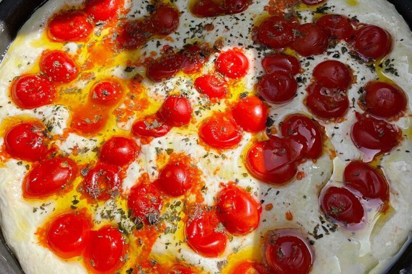 A pizza with tomato sauce, cheese, and herbs. 4