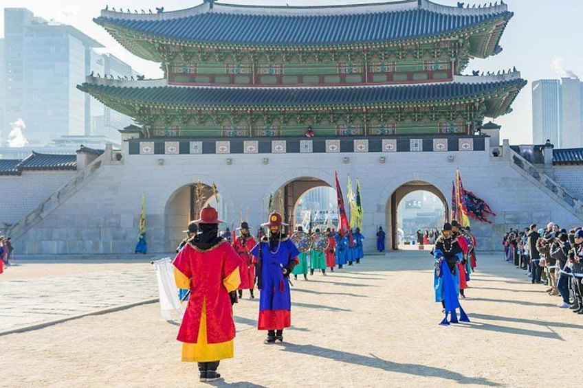 A traditional Korean gate with people in colorful hanbok. 1