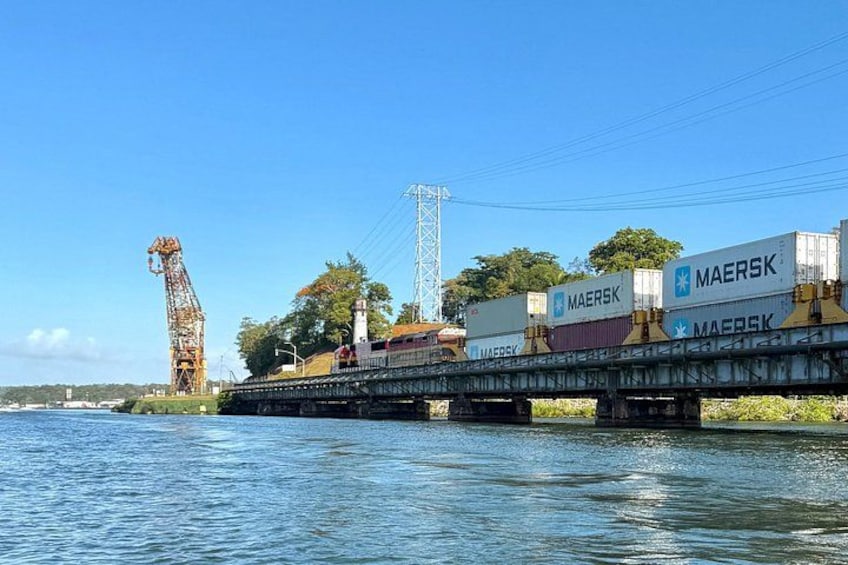 A cargo ship with containers marked 'MAERSK' on a river. 5