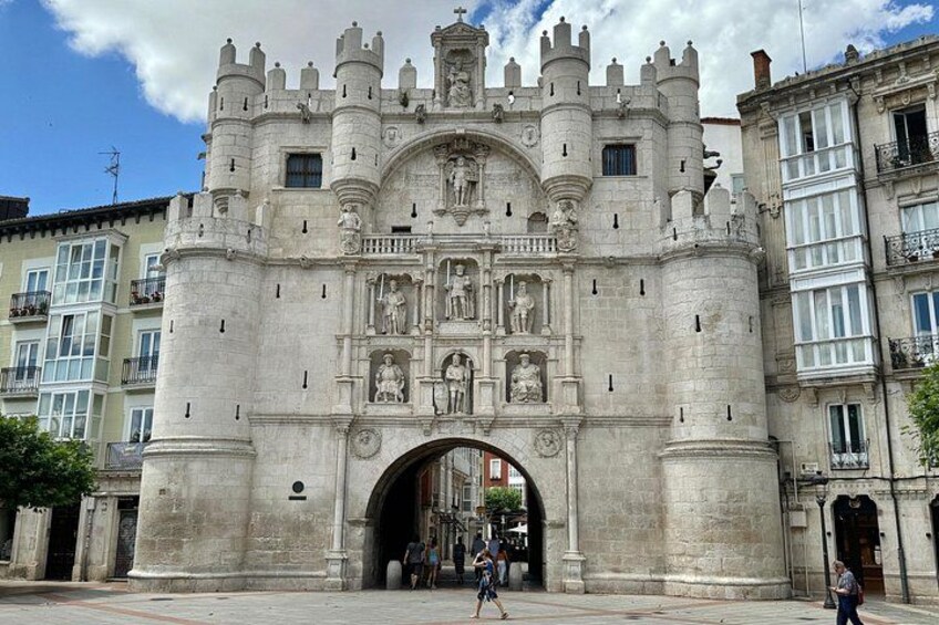 A historic stone gate with intricate carvings and a central archway. 5