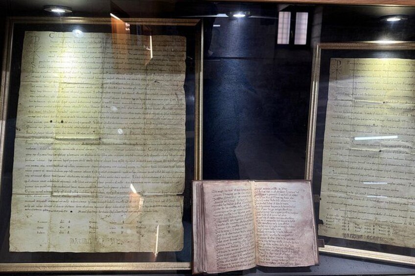 A display of old documents in glass cases. 2