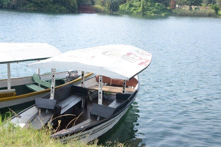 A rowboat docked at a pier with a canopy. 5