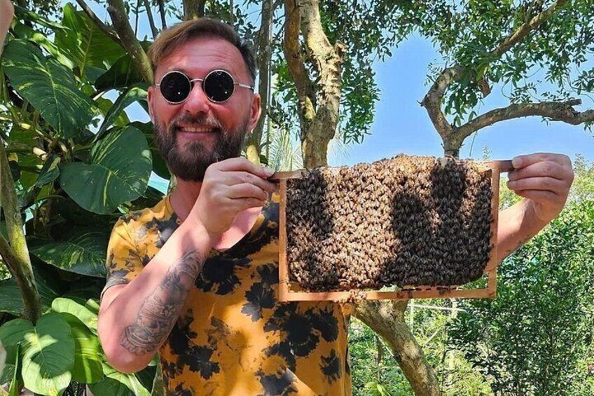 A person holding a beehive. 2
