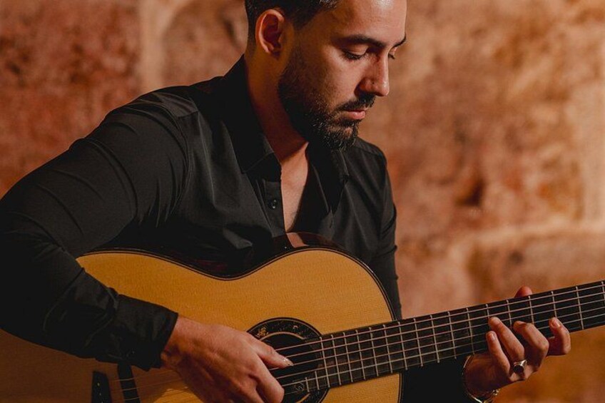 A person playing an acoustic guitar. 2