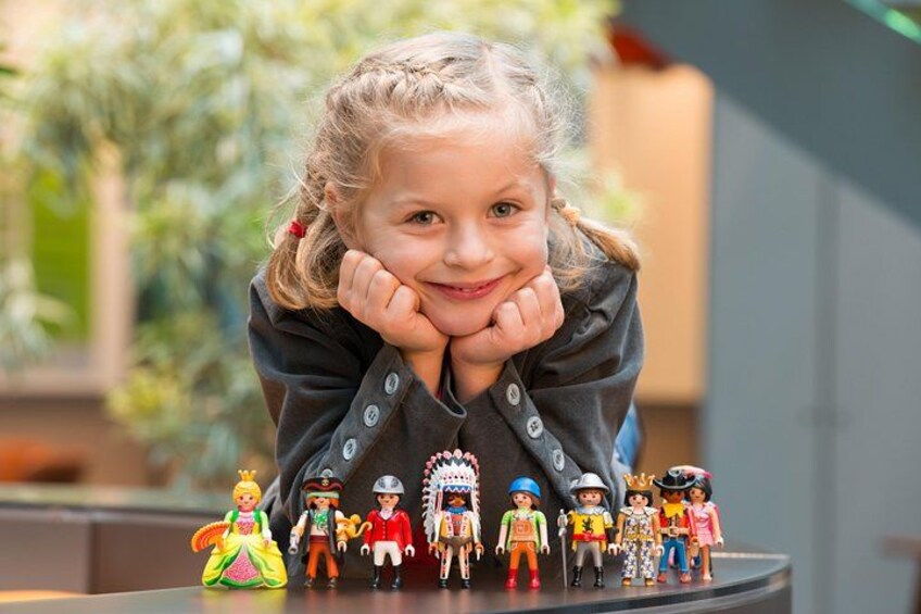 A child with a toy figure collection. 3