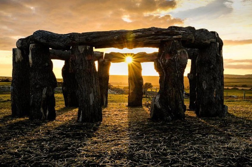 A stone structure with a sunset in the background. 5