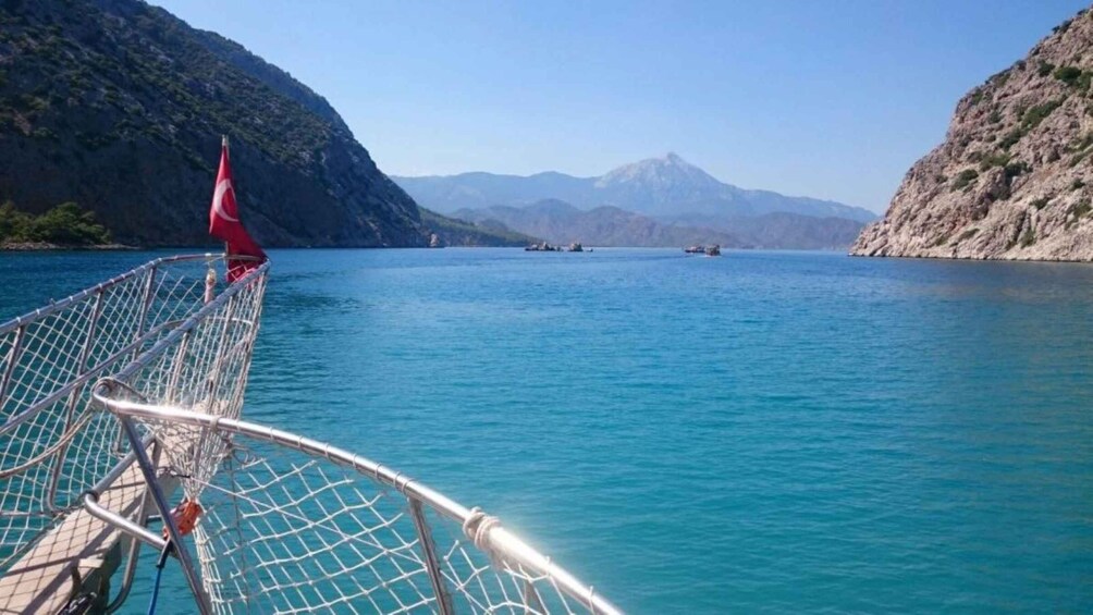 A boat on a calm lake with mountains in the background. 4