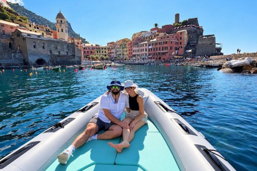 A boat on a calm water body with a historic town in the background. 4