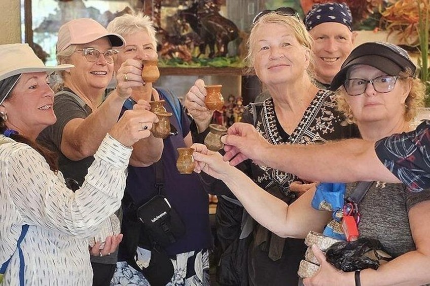 A group of people holding pottery items. 1